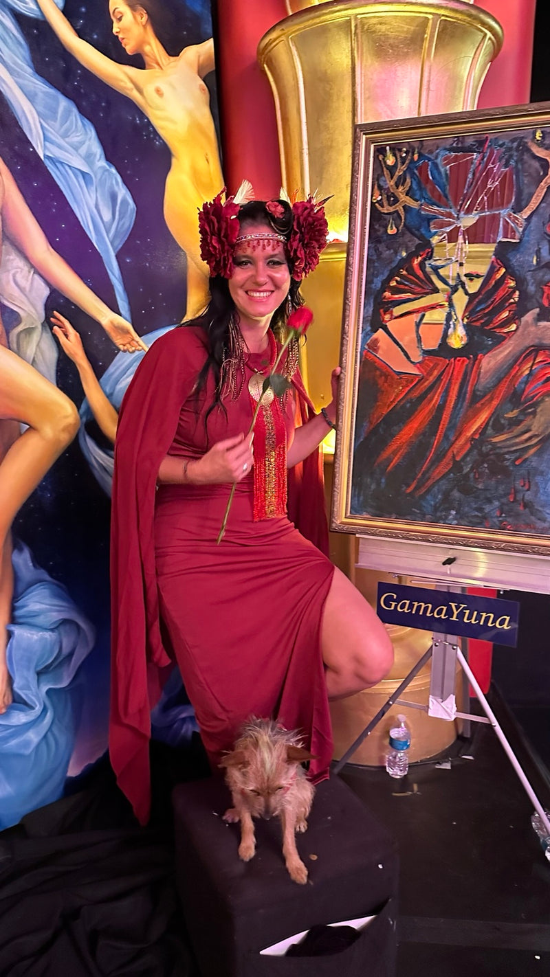 Gamayuna in red with her painting at an art event